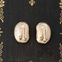 When we first came across this sweet pair of gold clip-on orbs, we knew we had to have 'em! Sweet and chic, these babies remind us of the goodies found in jewelry boxes of a cosmopolitan lady in the 1980's. They're bold and present, but hollow in make to allow for total comfort when worn. Perfect for daily wear, whether you're going for a glam gold look or just dressing up your jeans and T shirt. 14kt yellow gold Measures: 20.76mm L & 14.63mm W 7.7 grams Gold Metal Clip-on Earrings With Polished Finish, Formal Gold Brass Clip-on Earrings, Metal Clip-on Earrings With Polished Finish For Gift, Polished Metal Clip-on Earrings For Gift, Polished Metal Clip-on Earrings As Gift, Gold-tone Brass Clip-on Earrings For Formal Occasions, Gold Polished Clip-on Earrings For Gift, Gold Clip-on Earrings With Polished Finish As Gift, Gold Plated Clip-on Earrings With Polished Finish