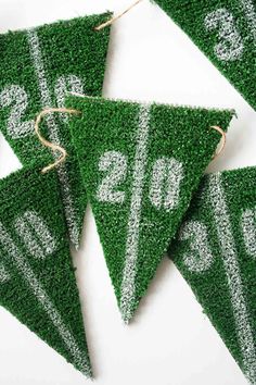 green grass pennants with white numbers on them