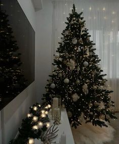 a decorated christmas tree in a living room with lights on the top and below it