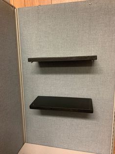 there are two shelves on the wall next to each other