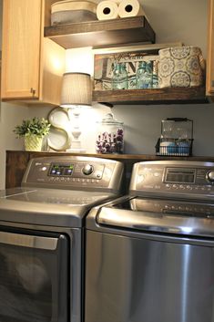 a washer and dryer sitting in a kitchen next to each other on top of cabinets