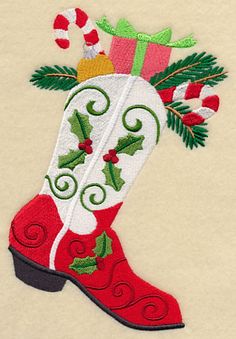 an embroidered christmas stocking with holly and candy canes on the boot is shown