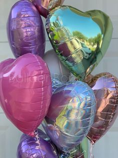 a bunch of heart shaped balloons are stacked on top of each other