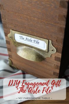 a wooden box with a label on it that says, diy engagement gift the aste file