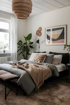 a bedroom with a large bed, rugs and plants on the wall above it