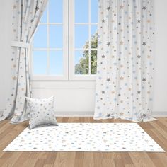 a white and blue room with stars on the curtains, flooring and window sill