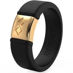 a black and gold wedding band with an emblem on it