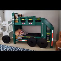 a child's bed made to look like a construction truck with wheels and tires