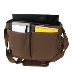 a brown messenger bag with a laptop and notepad in it's back pocket