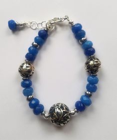 7.5-inch Bracelet - Blue faceted glass rondelles & silver toned round and rondelle beads, with silver toned accents. Blue Faceted Beaded Bracelets, Blue Faceted Rondelle Bracelets, Blue Rondelle Beaded Bracelets, Adjustable Faceted Blue Crystal Bracelet, Silver Crystal Bracelet With Large Beads And Adjustable Fit, Adjustable Silver Crystal Bracelet With Large Beads, Blue Beaded Rondelle Crystal Bracelet, Blue Nickel-free Beaded Bracelets With Round Beads, Nickel-free Blue Beaded Bracelets With Round Beads