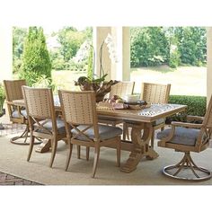 an outdoor dining table and chairs on a patio