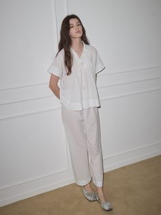 This pajama set features a relaxed fit for comfortable wear experience and collar design to add appeal to the item.- Availalbe in colors: Brown and white- Ribbon at the chest as a refined touch- Made from a soft fabric blend of cotton and tencel Elegant Relaxed Fit Sleepwear For Spring, White Cotton Sets For Workwear, White Relaxed Fit Sets For Pajama Party, White Feminine Sleepwear With Relaxed Fit, White Feminine Sleepwear For Relaxation, Spring White Relaxed Fit Sleepwear, Spring White Sleepwear With Relaxed Fit, White Relaxed Fit Sleep Set, Feminine White Lounging Sleepwear