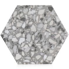 a hexagonal tile with white and black rocks on it, as well as the floor