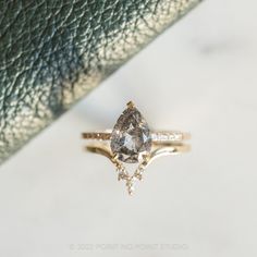 an engagement ring with a pear shaped diamond