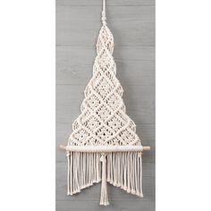 a white macrame hanging on a wall