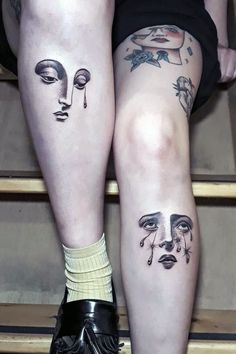 two women's legs with tattoos on them