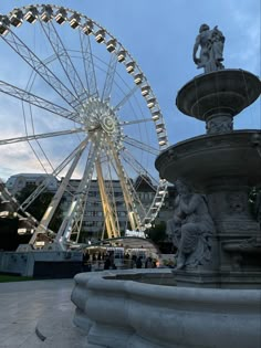 a large ferris wheel sitting next to a fountain