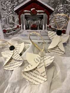 three pieces of paper with words written on them sitting next to a christmas card holder