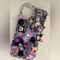 a cell phone case with lots of different items on the front and back cover,