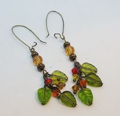 Leaf earrings with multicolored crystals and bronze accent beads on antique bronze kidney wires Cheap Earthy Dangle Earrings, Nature-inspired Beaded Dangle Earrings As Gift, Handmade Nature-inspired Dangle Beaded Earrings, Autumn Jewelry Earrings Dangle, Handmade Fairycore Dangle Earrings, Nature-inspired Brown Dangle Earrings, Brown Dangle Earrings Nature-inspired, Simple Bead Earrings, Fall Earrings