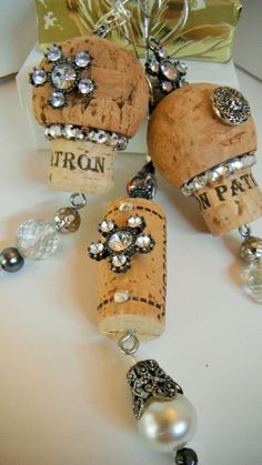 three wine corks with charms attached to them