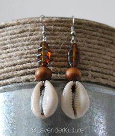 Handmade using natural cowrie shells and czech beads. Approximately 2.5 inches long. One of a kind earrings. Handmade Teardrop Beaded Earrings For Beach, Handmade Cowrie Shell Earrings For Beach, Brown Beaded Earrings For Beach With Dangling Beads, Bohemian Adjustable Cowrie Shell Earrings, Brown Dangling Bead Earrings For Beach, Brown Beaded Dangling Earrings For Beach, Bohemian White Cowrie Shell Earrings, Unique Beaded Drop Earrings For Beach, Bohemian Adjustable Dangle Shell