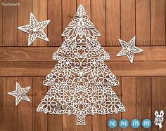 the cut out paper christmas tree is next to three star decorations on a wooden surface