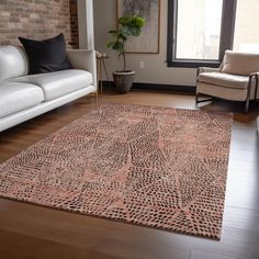 a living room with two white couches and a large rug on the hardwood floor