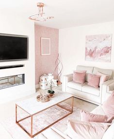 a living room filled with furniture and a flat screen tv mounted on the wall above a fireplace