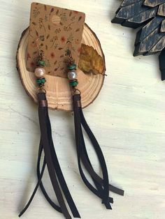 This is a pair of long leather lariat tassel earrings with copper findings. The wire-wrapped gemstones are iridescent faceted moonstones with Czech turquoise rondelle beads, and I have added the beautiful rustic copper fold over crimps to hold the leather strands. The high quality dark chocolate leather (not suede) is super soft and the earrings are very lightweight and comfortable to wear. The leather tassels by themselves measure 4 - 4 1/2". You will love wearing these! Adjustable Brown Bohemian Tassel Earrings, Artisan Brown Jewelry With Tassels, Bohemian Hand Wrapped Brown Earrings, Bohemian Brown Hand Wrapped Earrings, Bohemian Brown Hand-wrapped Earrings, Wrapped Gemstones, Leather Tassel Earrings, Chocolate Leather, Western Jewelry