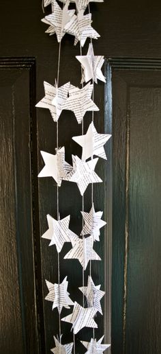 some paper stars hanging from the side of a door