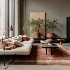 a living room filled with lots of furniture and plants in vases on the wall