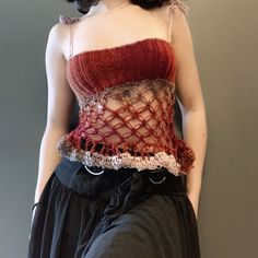 a mannequin wearing a red top with crochet on it's chest