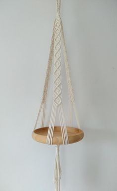 a macrame hanging from a wooden shelf