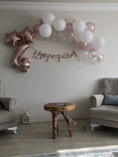 a living room filled with furniture and balloons