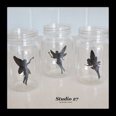 three glass jars with tinkered fairy images on them