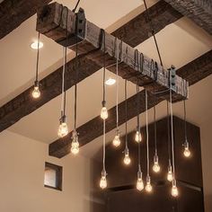 the light bulbs are hanging from the beam in the room, which is decorated with wood beams