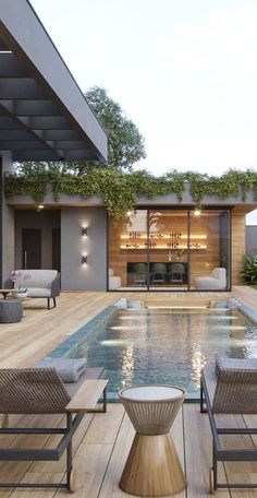 an outdoor swimming pool with lounge chairs and tables next to it, surrounded by greenery