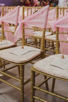 chairs with pink sashes and napkins on them