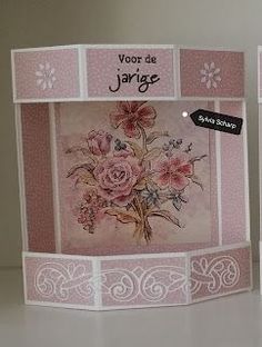 two cards with pink flowers on them sitting next to each other