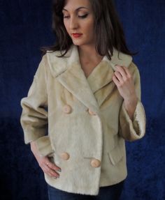 "Very striking 1950s faux fur blazer.   The fabric is very unusual--it's not really thick fur as most faux furs, but is flat and shiny.   You could wear it as a blazer to the office or as an jacket on cool evenings. The color is cream with a golden hue.   Double breasted with four big buttons on the front.  Two flap pockets. Fully lined in shiny and soft satin fabric.  Classic and elegant 1950s bracelet sleeves.  A wide collar--another 50s style detail. The label reads: Brazotta, a Luxurious Fab 1950s Jacket, Fur Blazer, 1950s Bracelet, Brown Faux Fur Coat, Harley Davidson Boots, Fur Collar Coat, 50s Style, Embroidered Cardigan, Collared Coat