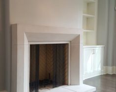 an empty living room with a fireplace in it