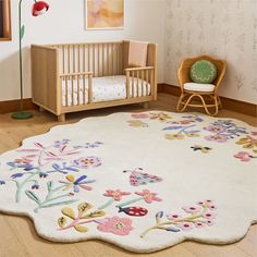 a baby's room with a crib, chair and rug