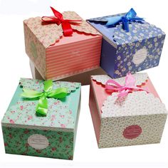 four different boxes with bows and ribbons on them