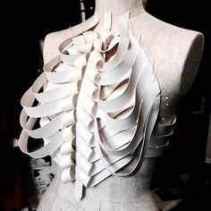 a mannequin is covered in white paper