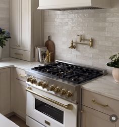 a white stove top oven sitting inside of a kitchen next to a counter with flowers on it