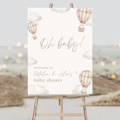 a baby shower sign with hot air balloons