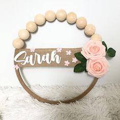 a wooden sign that says zarah with flowers on it