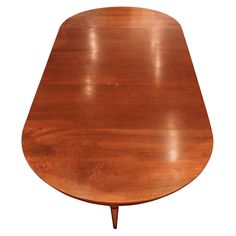 an oval wooden table with two legs and a single leaf on the top, against a white background