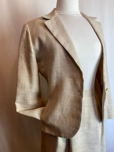 "Very well & nicely hand made vintage linen suit. Fully lined. In perfect condition. Raw un bleached linen color, natural. Nubby heavy weight linen. Structured. Single button blazer with pockets. 2 wide pleats in the front of skirt. Gathers in the back. A line shape. Hits about just below the knee. This suit jacket has shoulder pads ( Belt is for photos only) I have great belts though if you're looking! 😊 ✏️✏️DETAILS ✏️✏️✏️ Brand: hand made Size on tag: none Fits like: 8 ish please check measur Fitted Beige Linen Suit, Beige Single-breasted Summer Suit, Beige Single Breasted Summer Suits, Fitted Linen Blazer With Notch Lapel, Fitted Cream Linen Blazer, Beige Notch Lapel Blazer For Summer, Fitted Neutral Suits For Spring, Neutral Fitted Suit For Spring, Summer Formal Cream Blazer